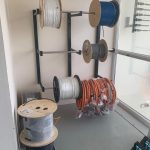 Wall-mounted cable spool rack